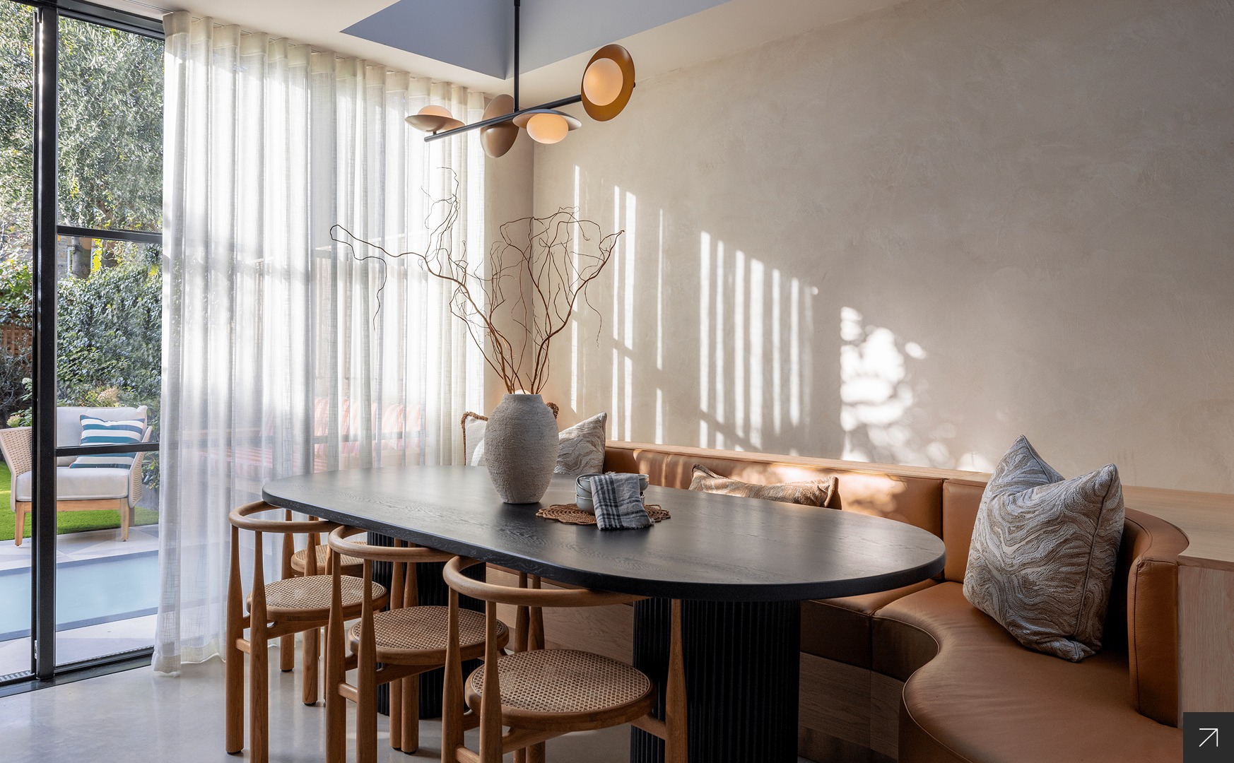 Contemporary London home interior with custom dining area, banquette seating and natural light-filled space