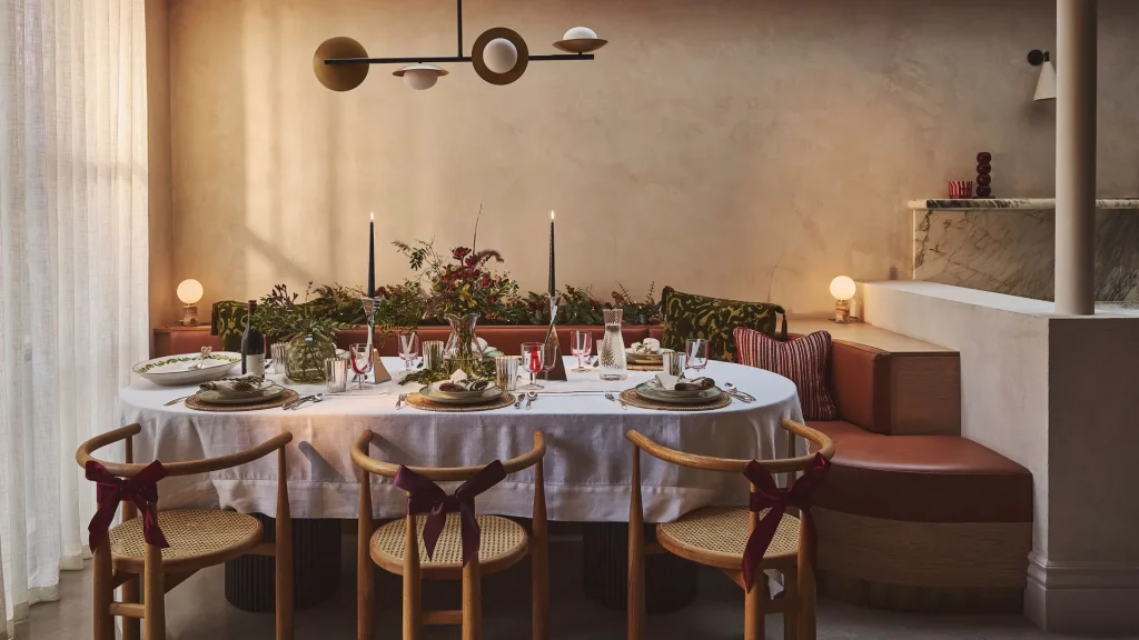 Luxury dining room styling with table setting, candles, floral arrangement and modern interior design